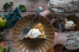 a person holding a plate with a slice of pie on it