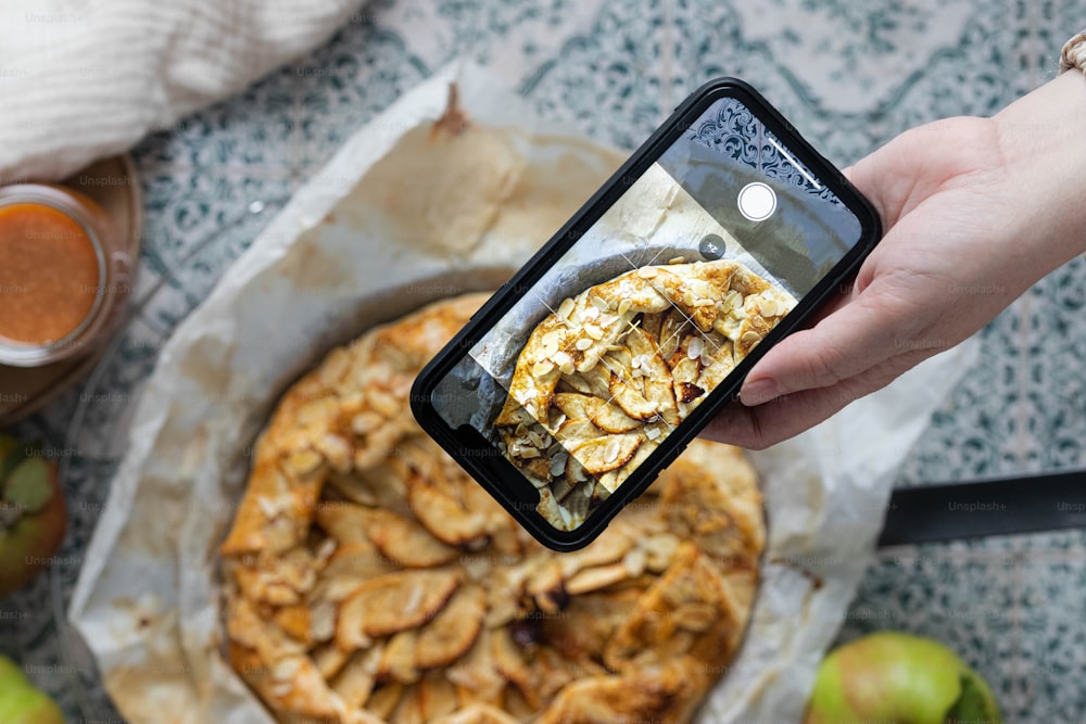 a person taking a picture of food on their phone