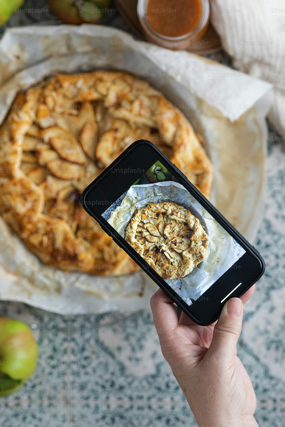 a person taking a picture of a pie