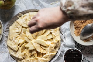 a person is making a pie on a table