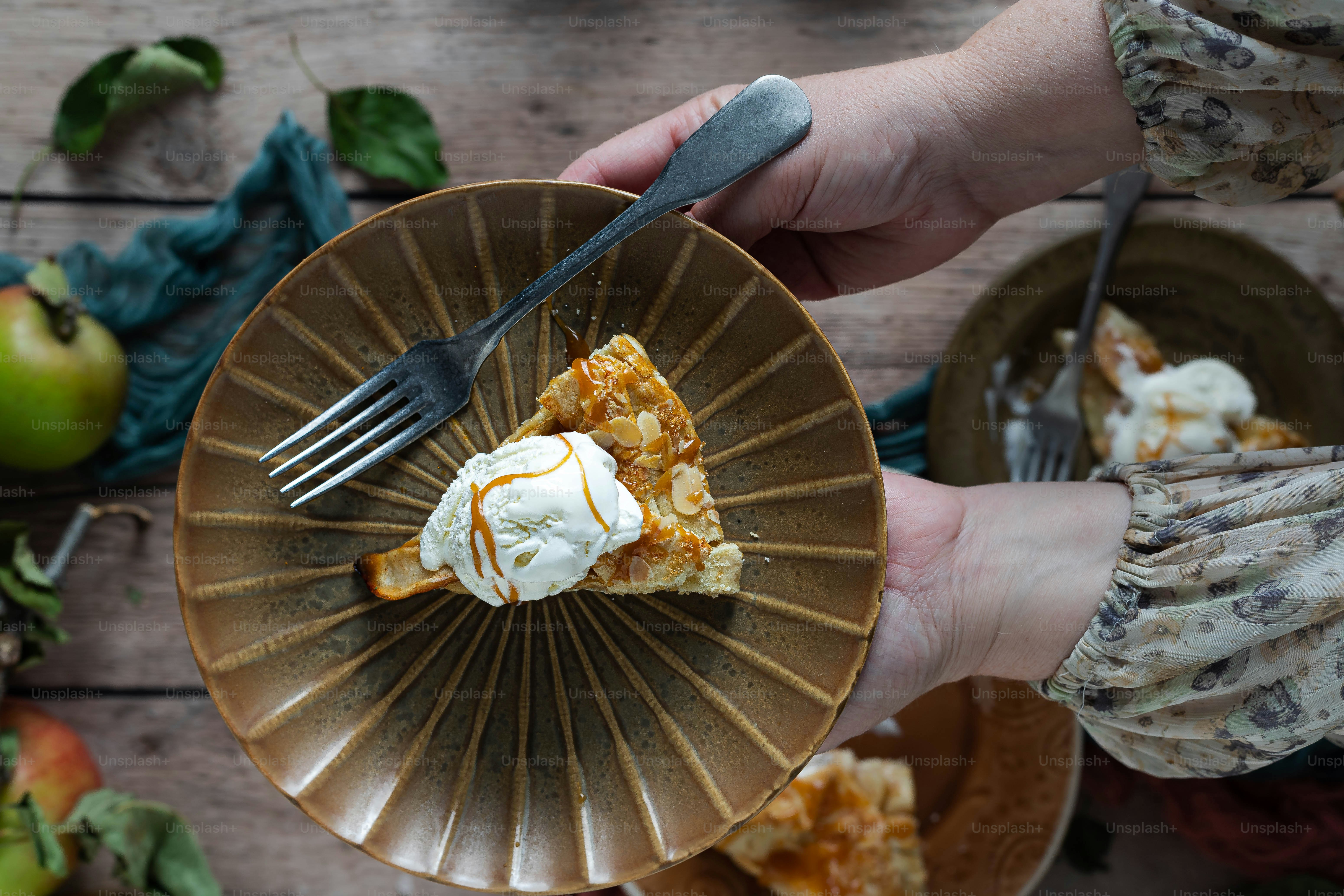 a person holding a plate with a slice of pie on it