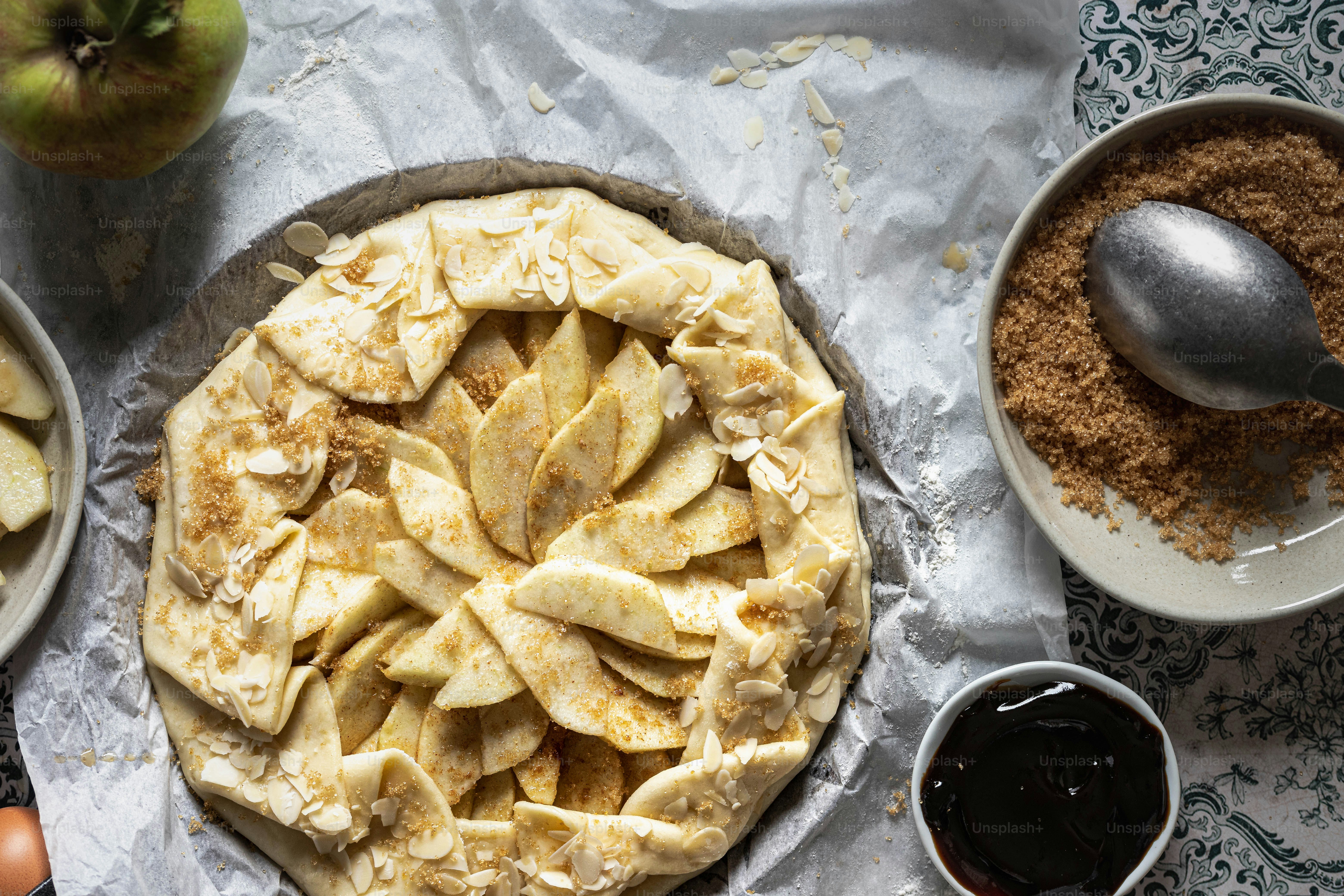 a pie sitting on top of a table next to bowls of food