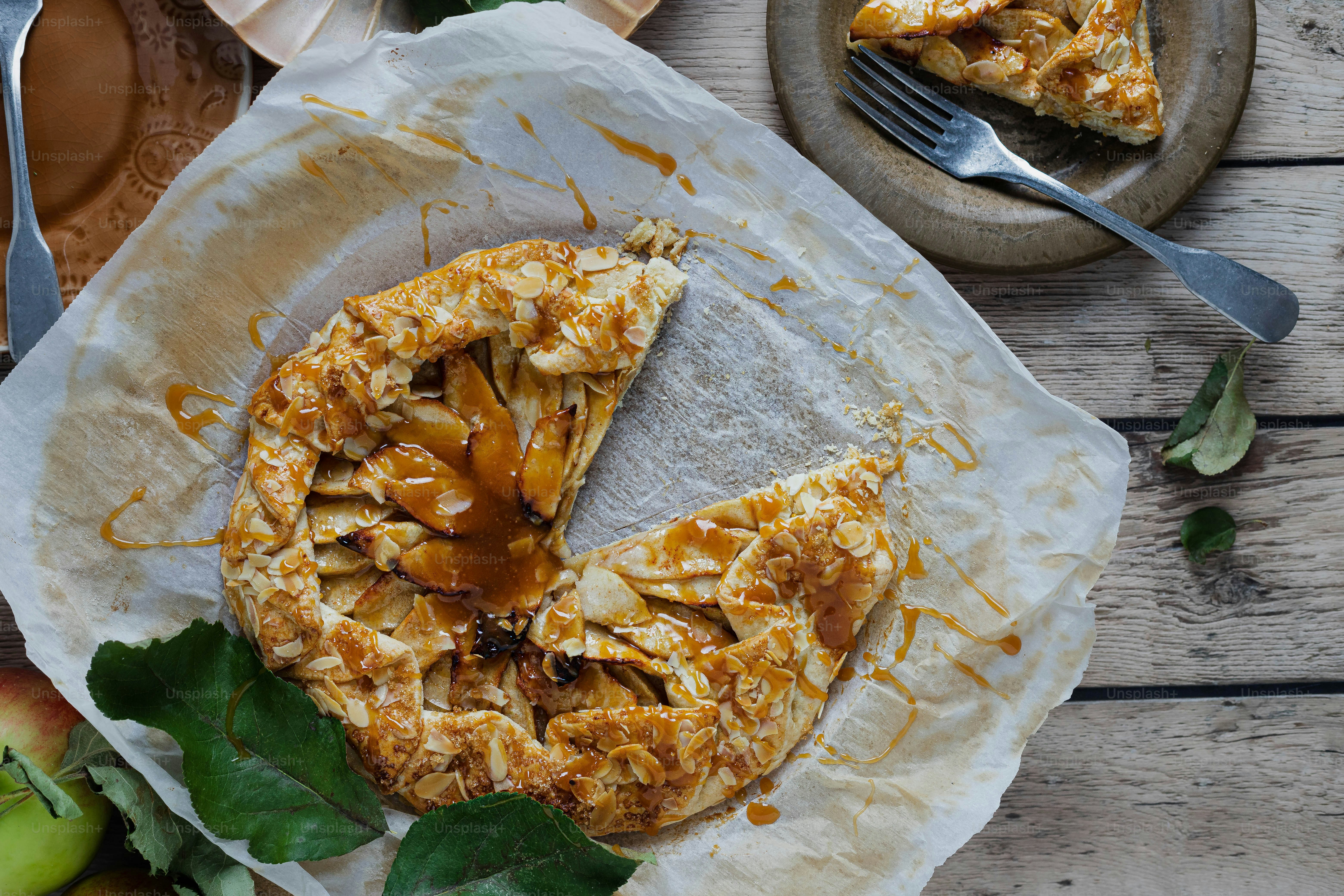 A close up of a pie with almonds and other toppings photo – Food Image ...