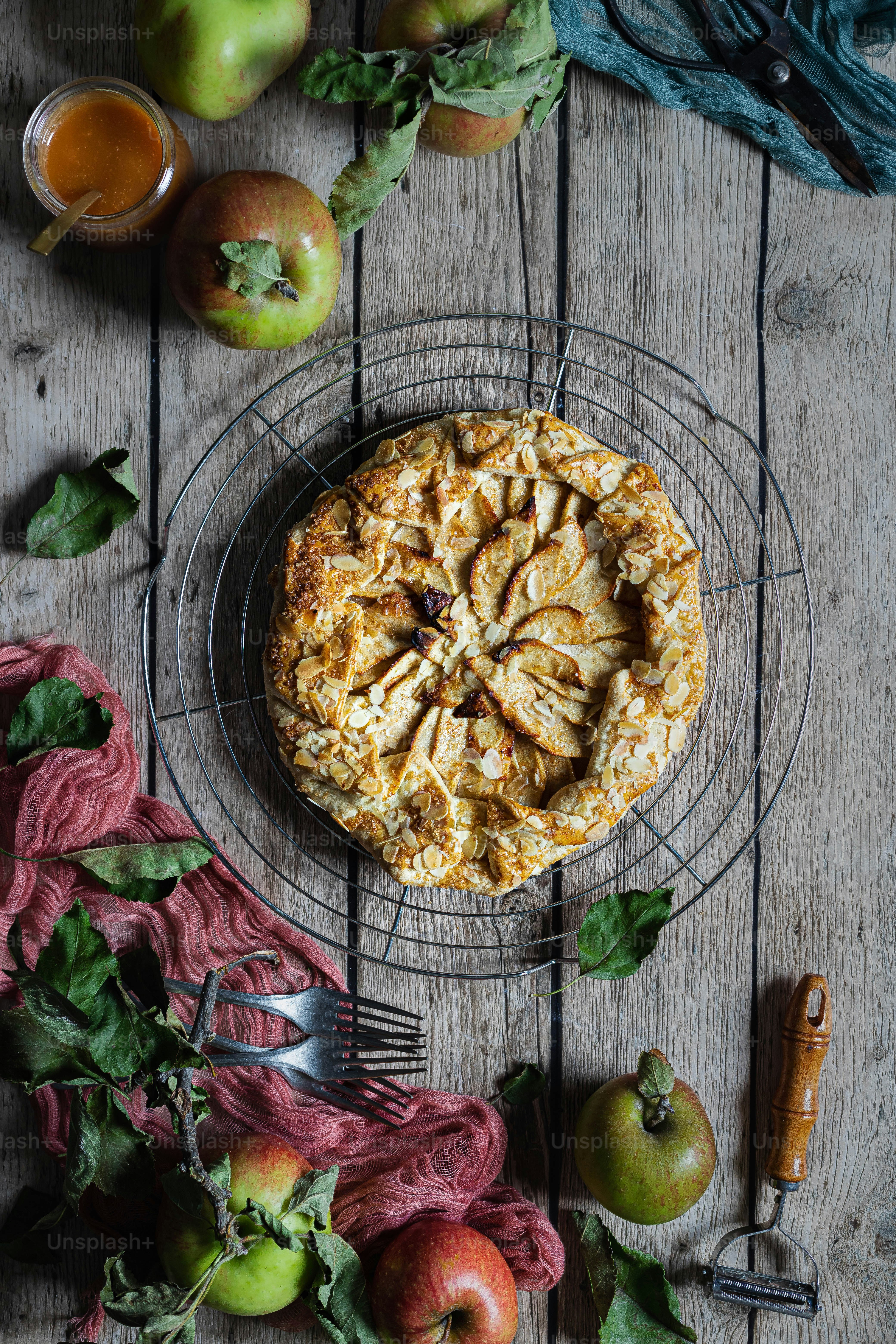 a pie on a wire rack surrounded by fruit