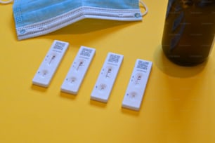 five disposable face masks, a face mask, and five test strips