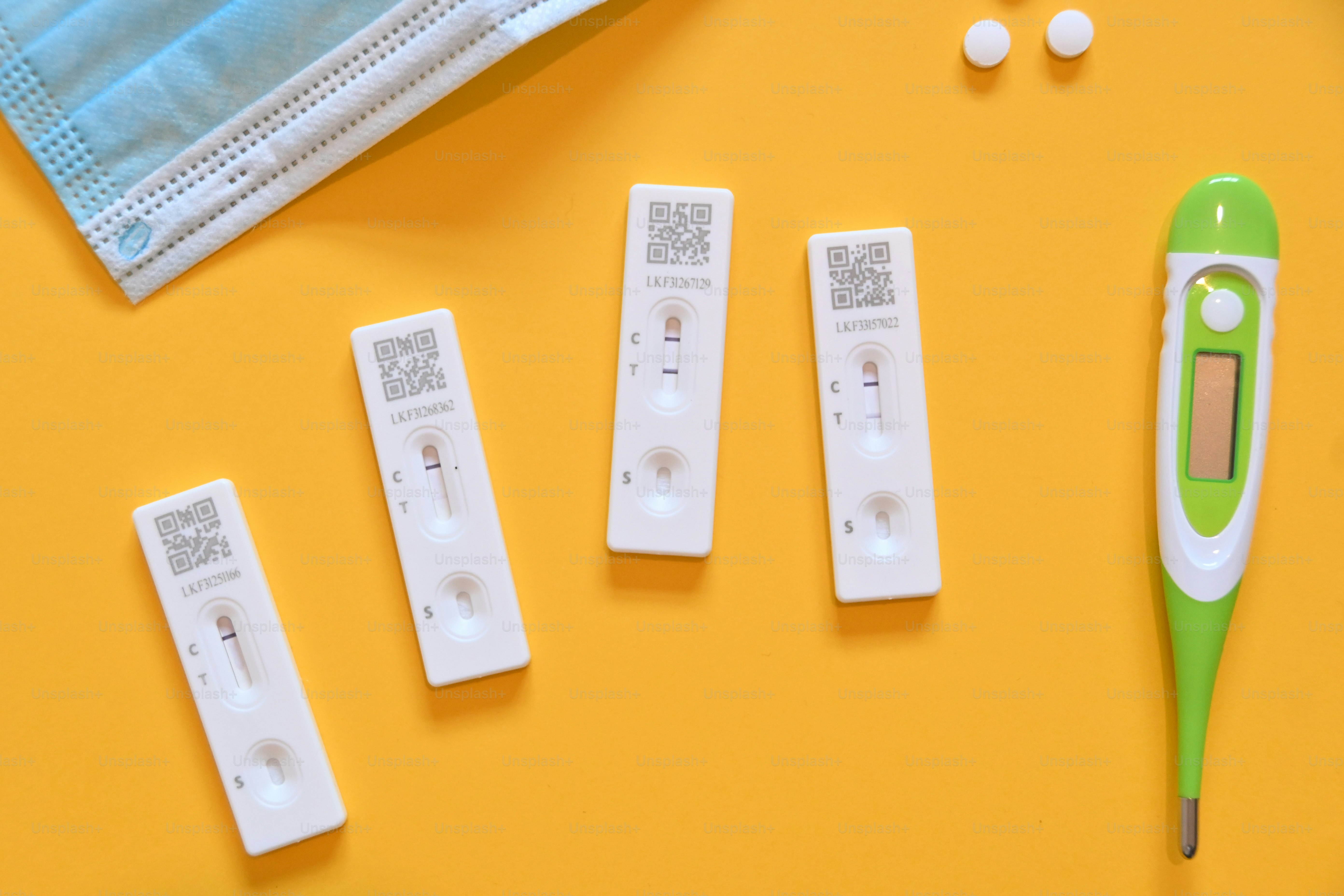 a green thermometer sitting on top of a yellow table