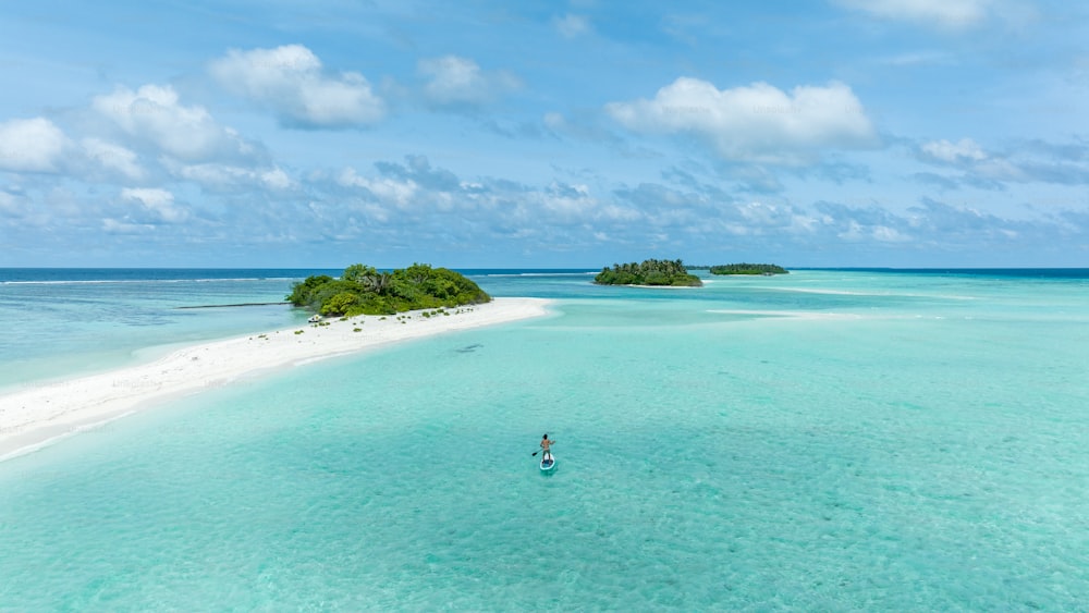 a person on a surfboard in the middle of the ocean