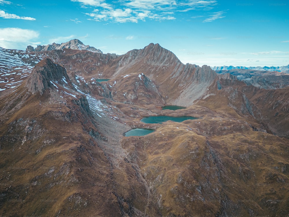 an aerial view of a mountain range with a lake in the middle