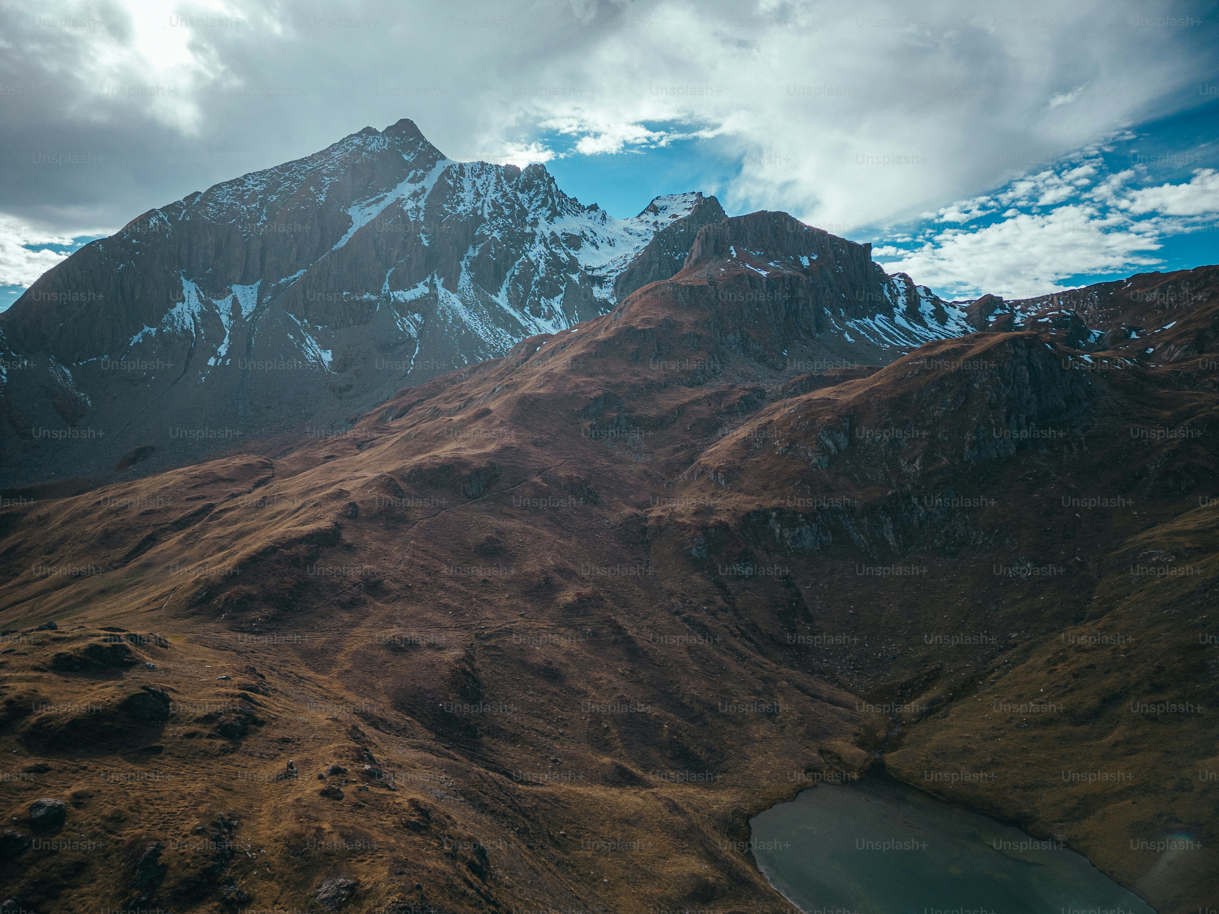 a mountain range with a lake in the foreground