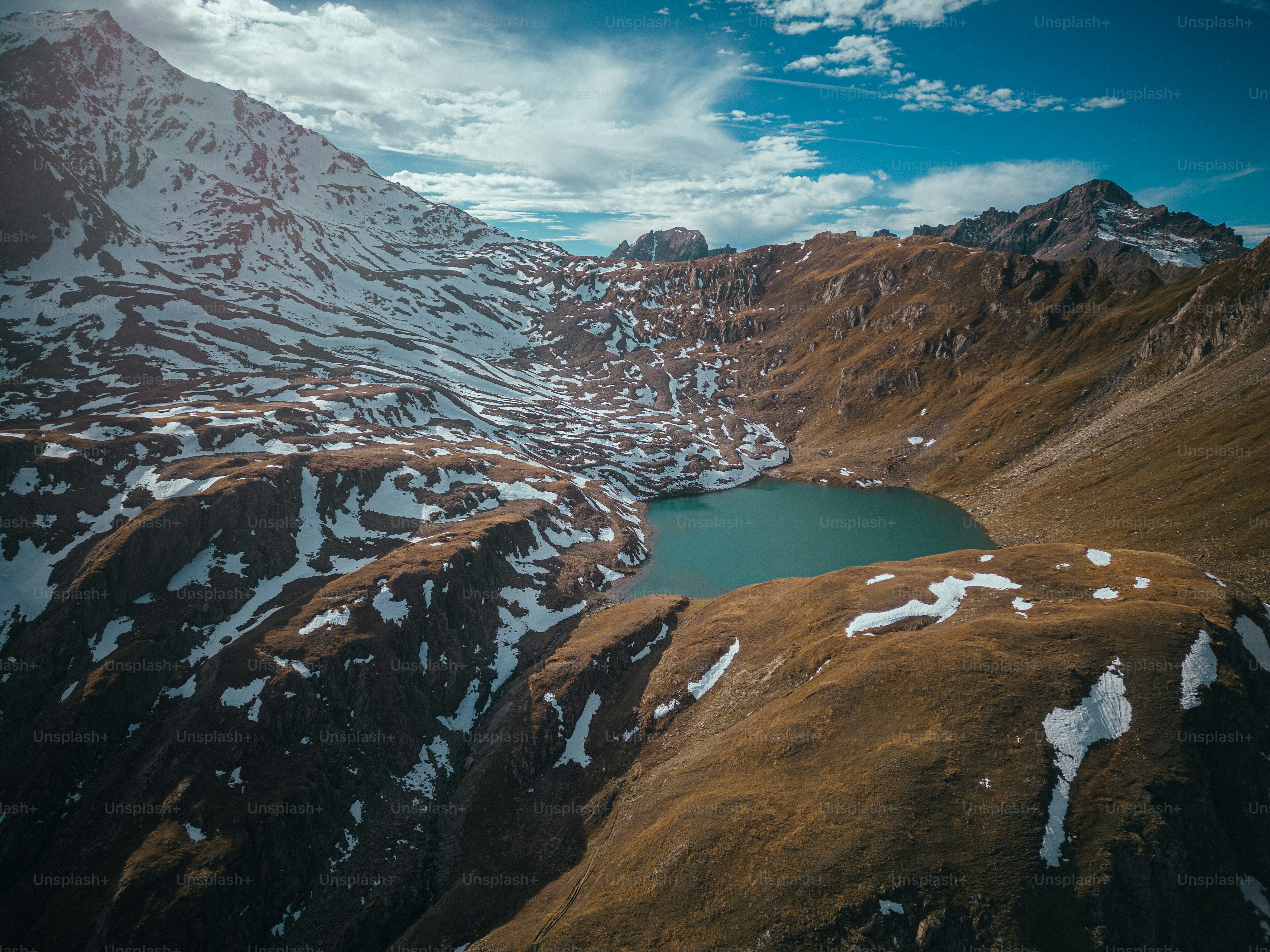 an aerial view of a mountain range with a lake in the middle