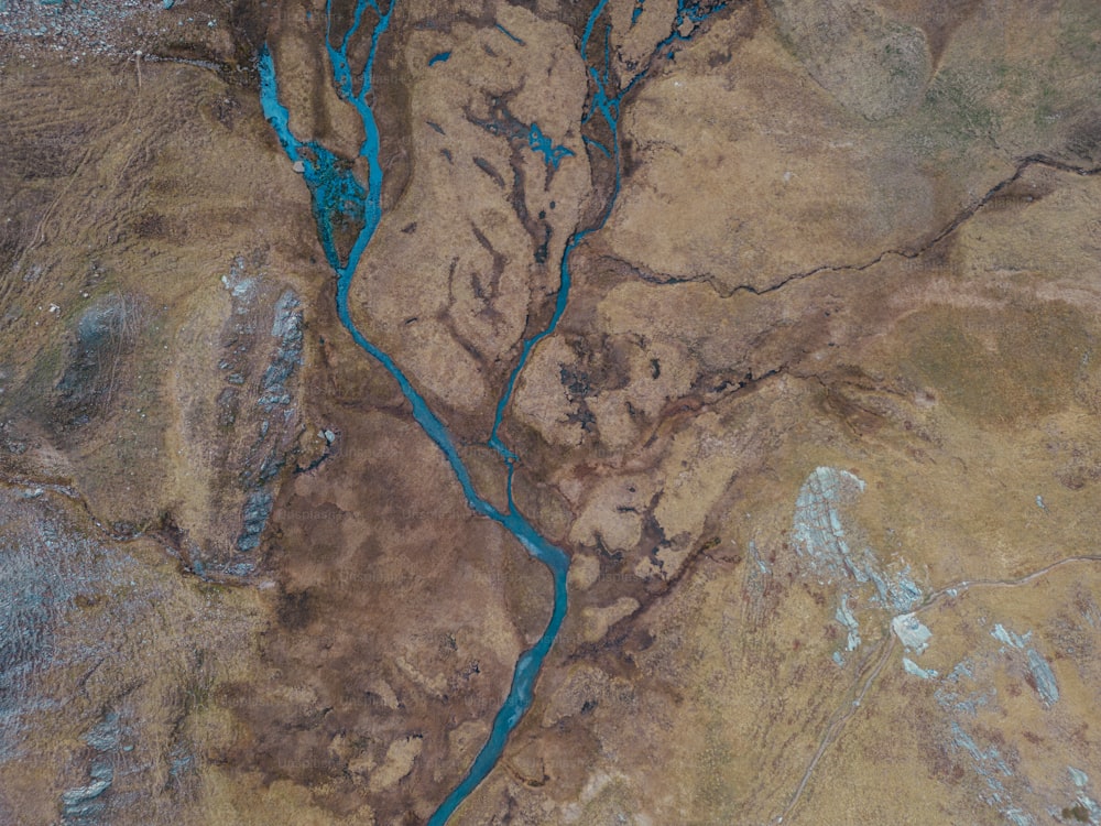 an aerial view of a river running through a desert