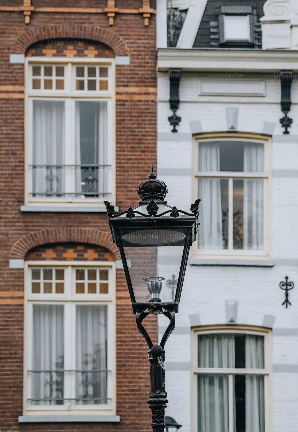 a lamp post in front of a brick building