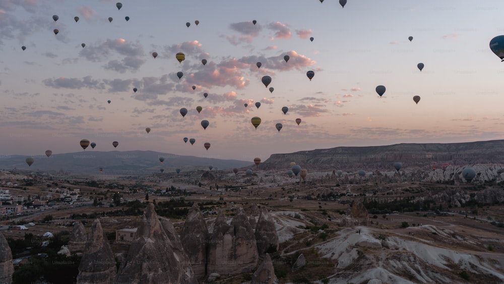 a bunch of hot air balloons flying in the sky