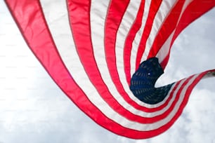 a large american flag flying in the sky