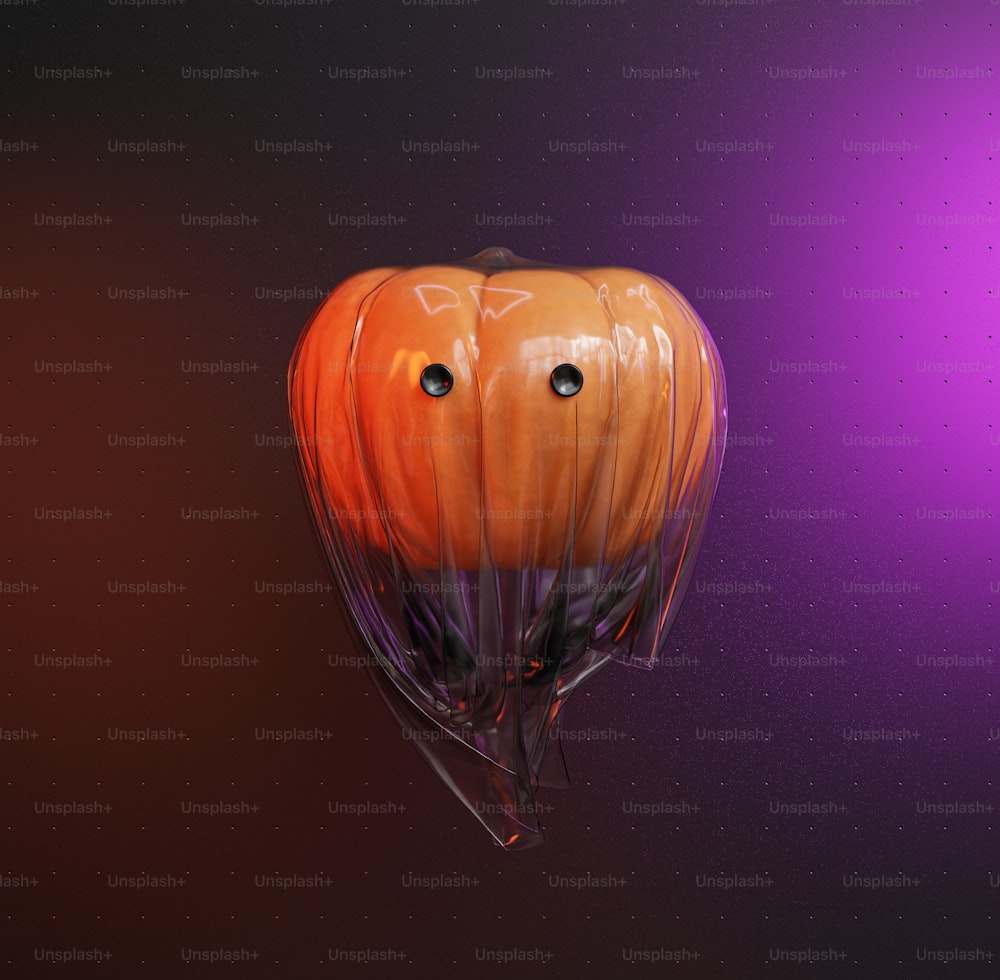 an orange and black balloon with eyes on it