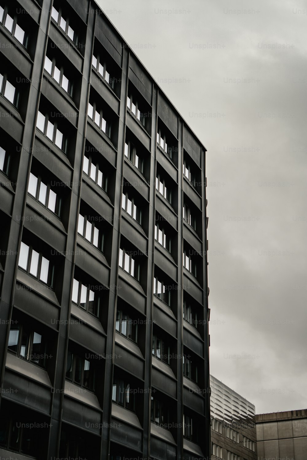 a tall black building with lots of windows