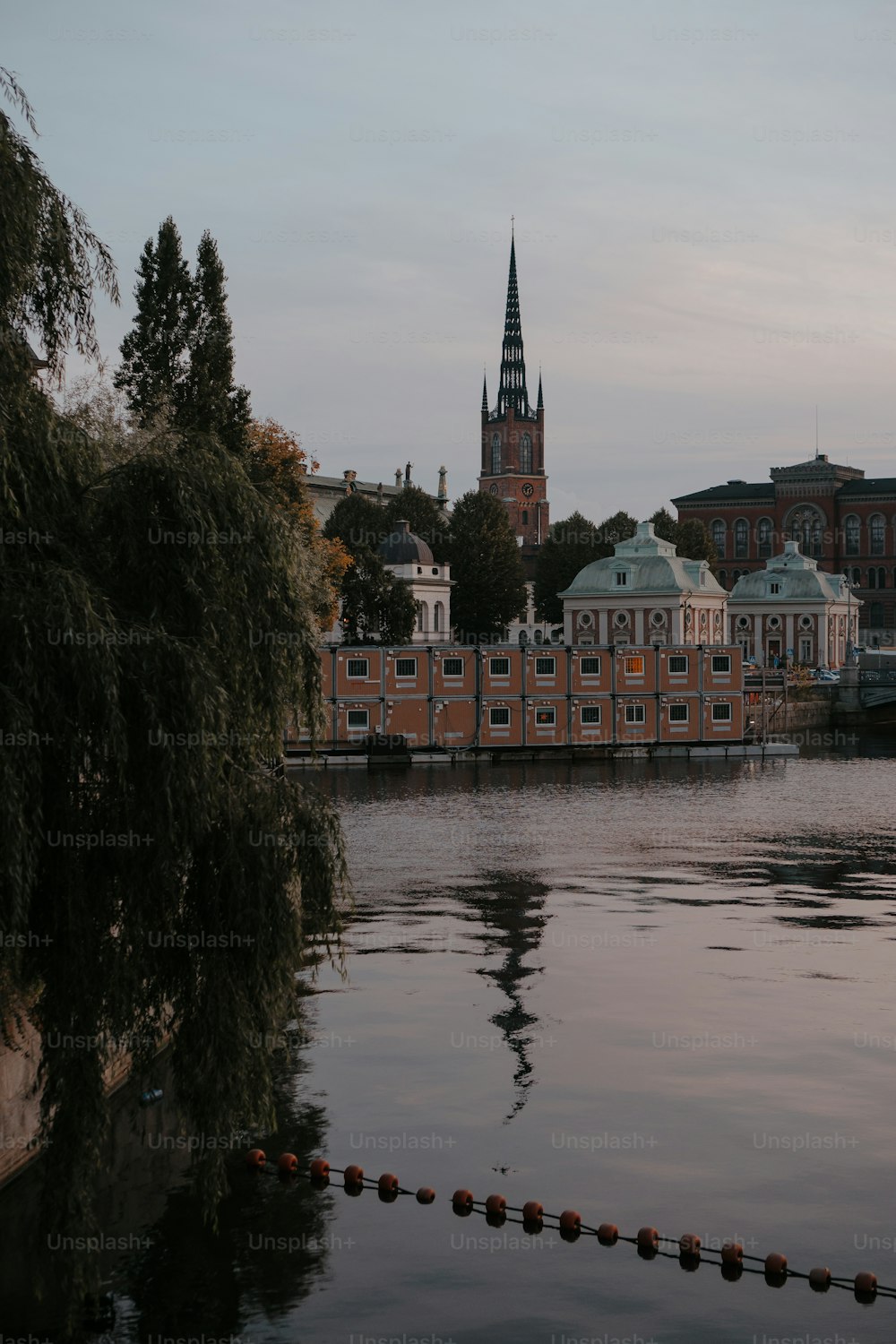 a large body of water with buildings in the background