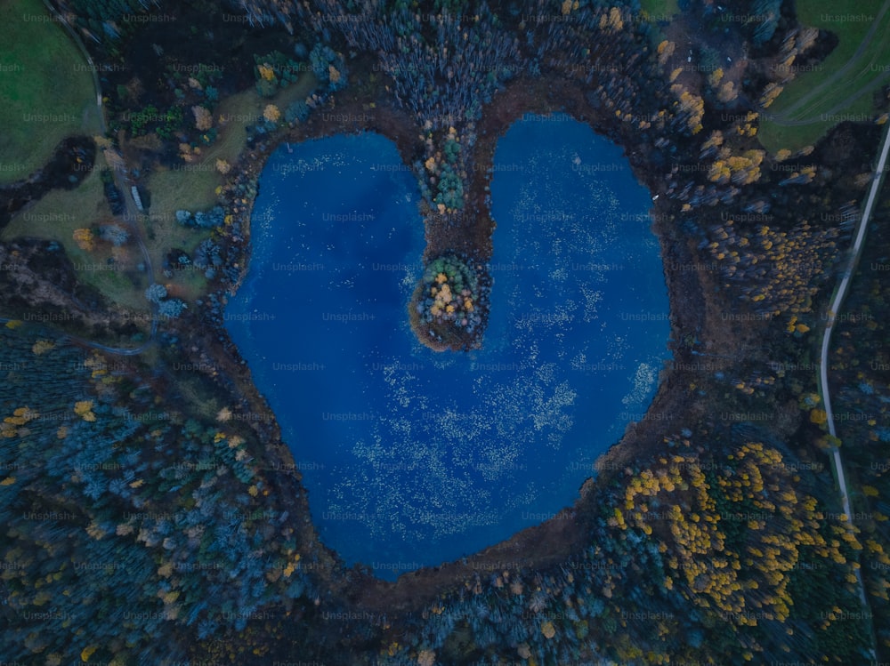 an aerial view of a heart shaped lake