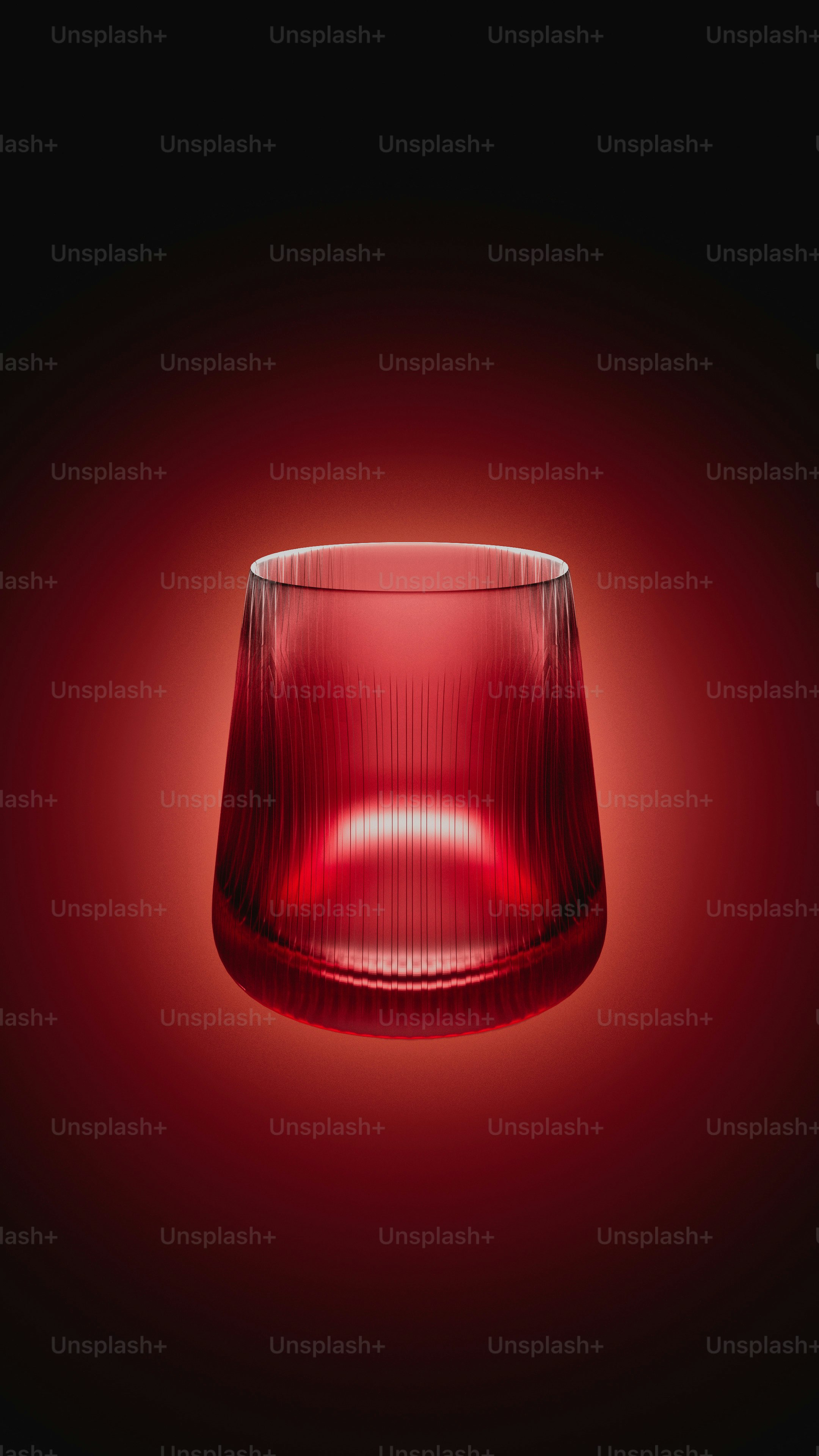 a close up of a red glass on a black background