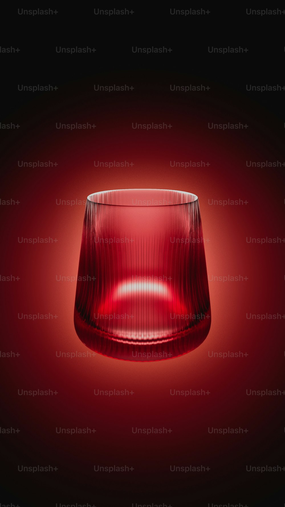 a close up of a red glass on a black background