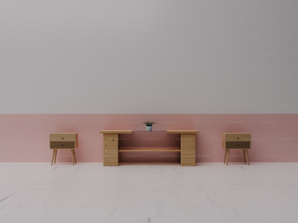 a pink and white room with two wooden tables