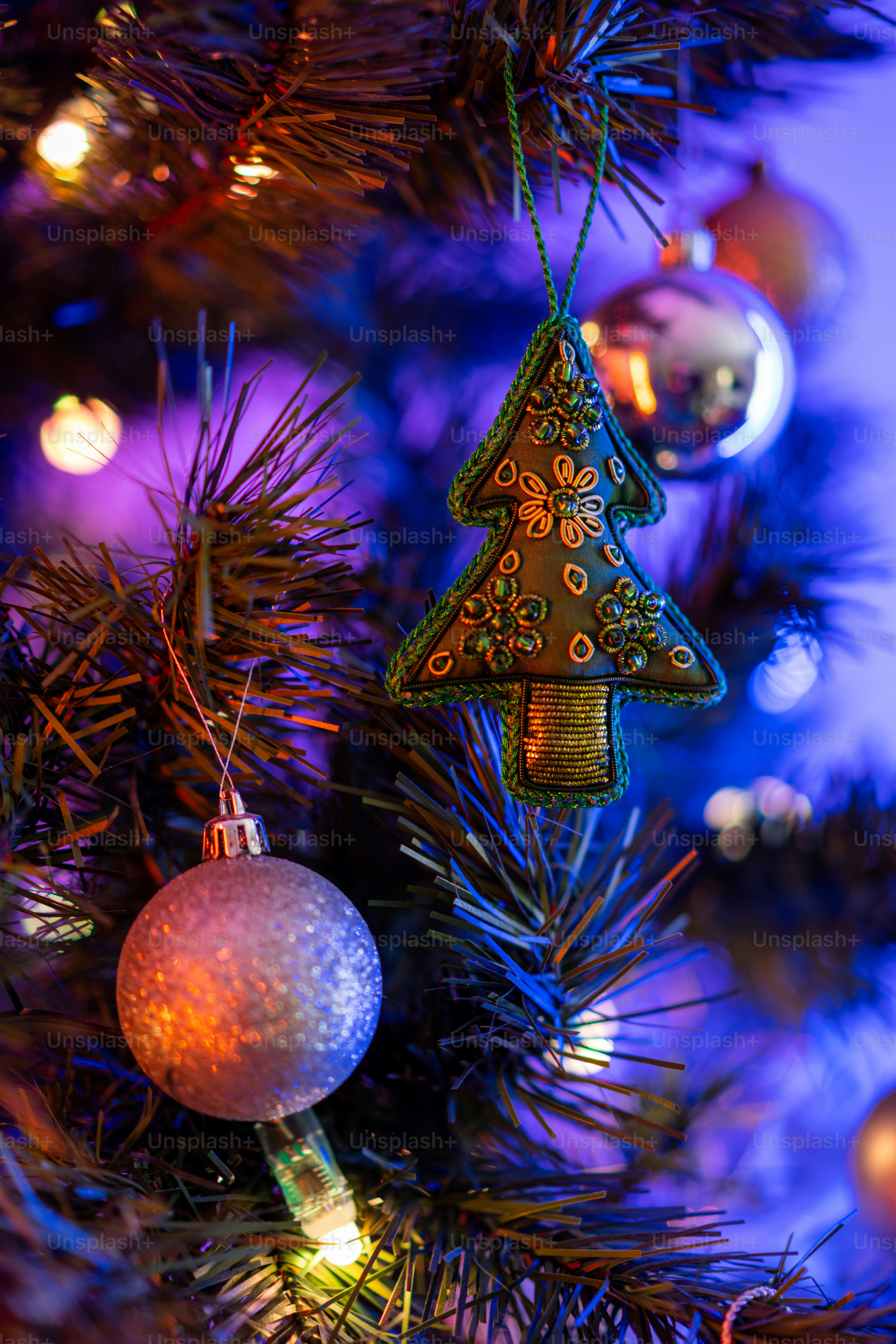 a close up of a christmas tree with ornaments