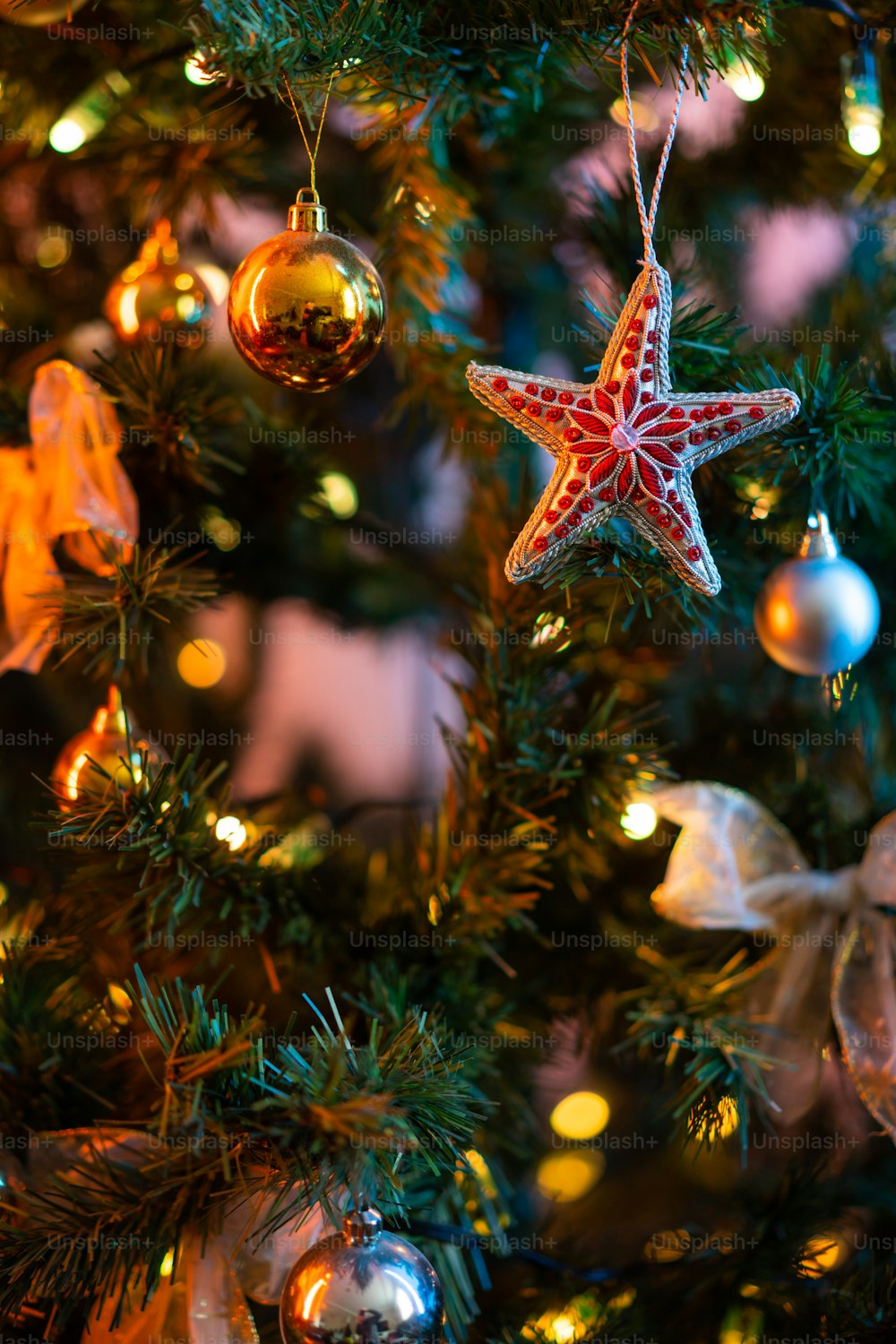 a starfish ornament hanging from a christmas tree