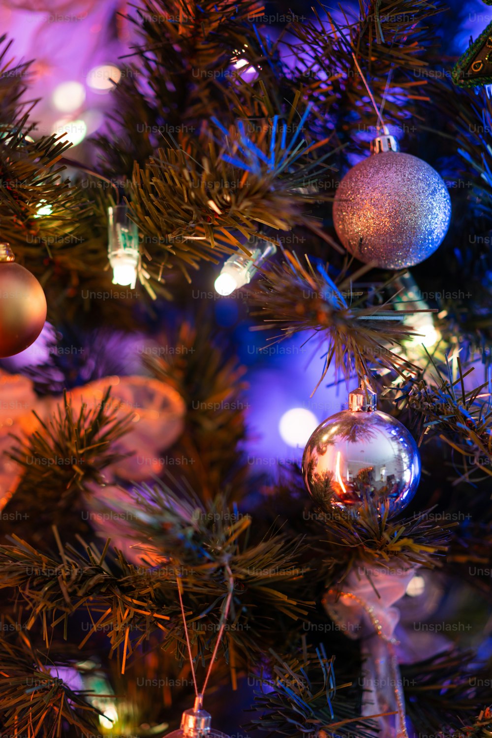 a close up of a christmas tree with ornaments