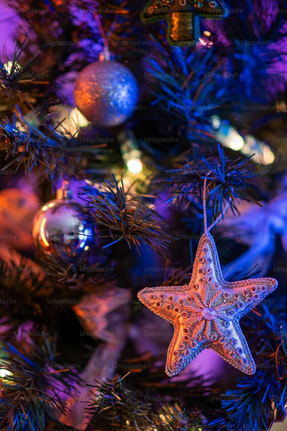 a starfish ornament hanging from a christmas tree