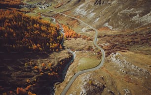 an aerial view of a winding road in the mountains