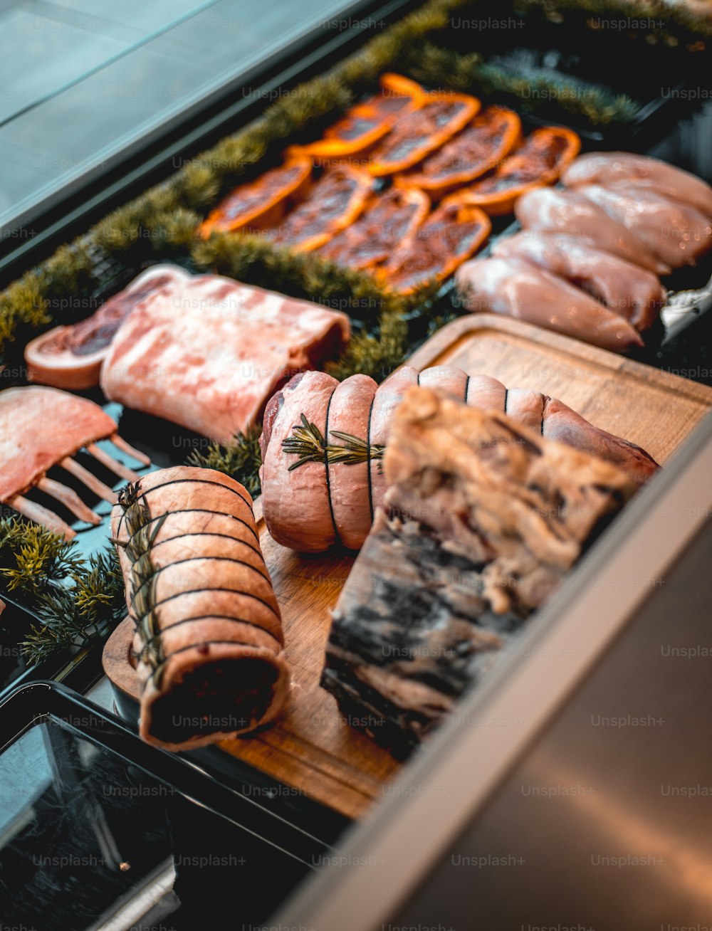 a display of meats and sausages in a display case