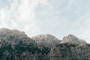 a mountain range with a few clouds in the sky