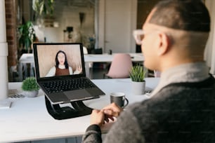 a man sitting in front of a laptop computer