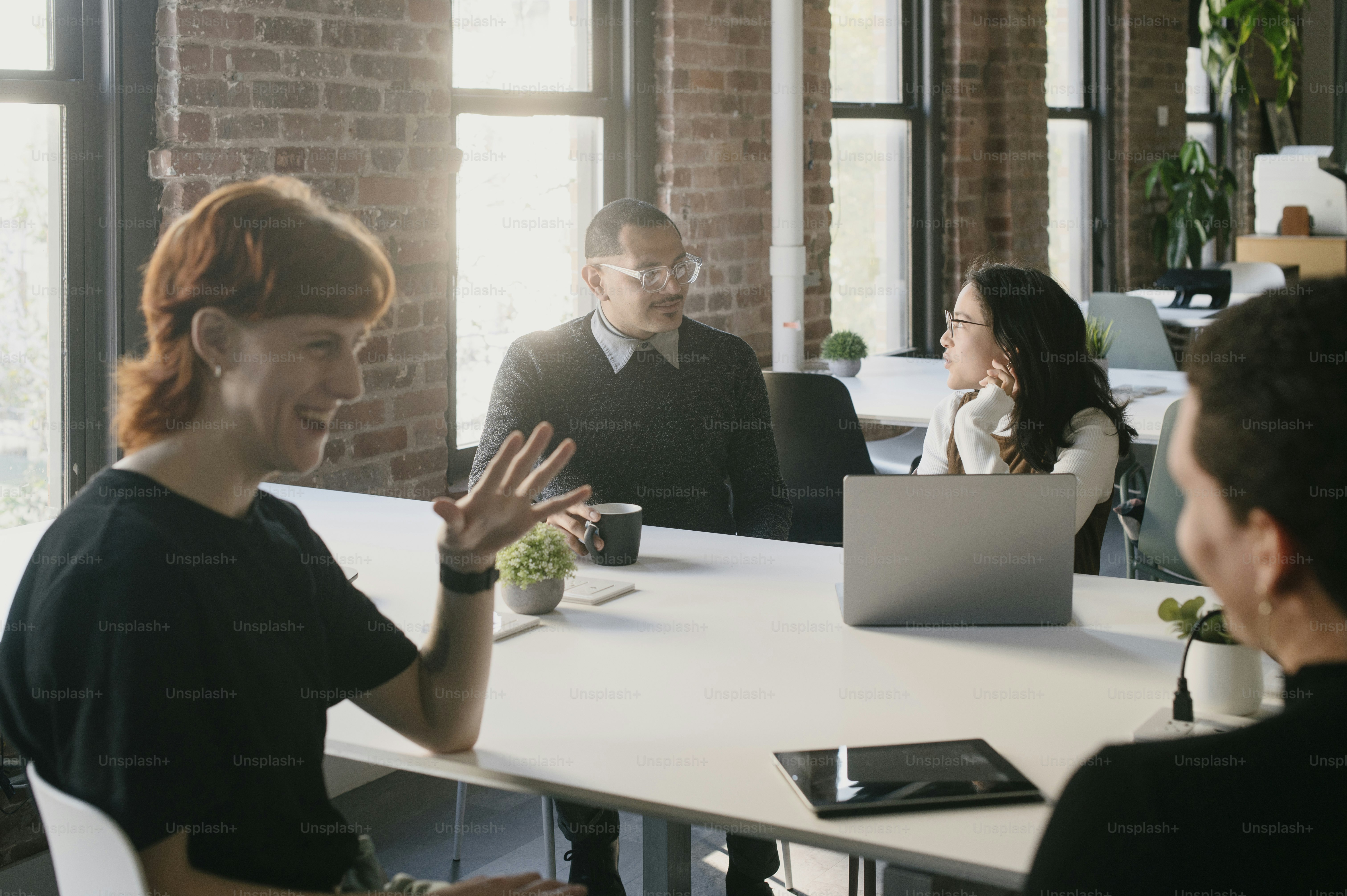 a group of people sitting around a white table