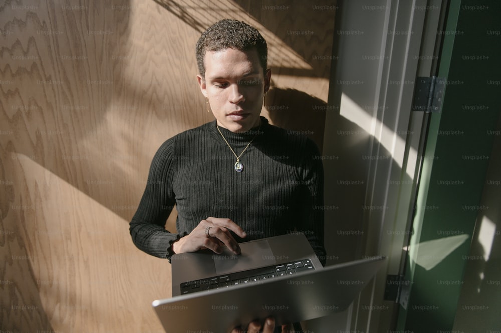 a man standing in front of a laptop computer