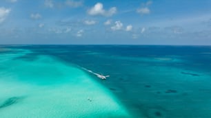 an aerial view of a boat in the ocean