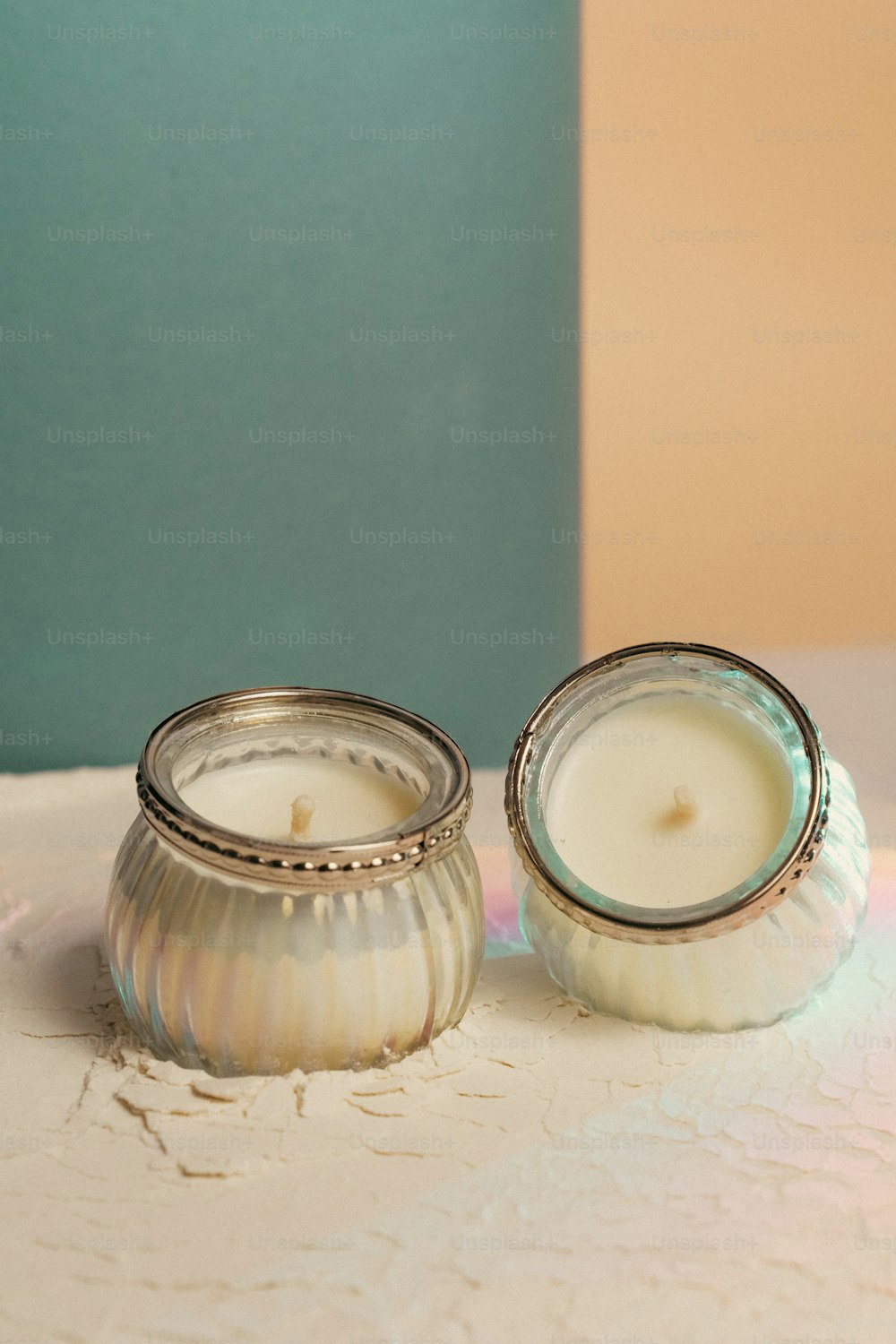 two candles sitting next to each other on a table