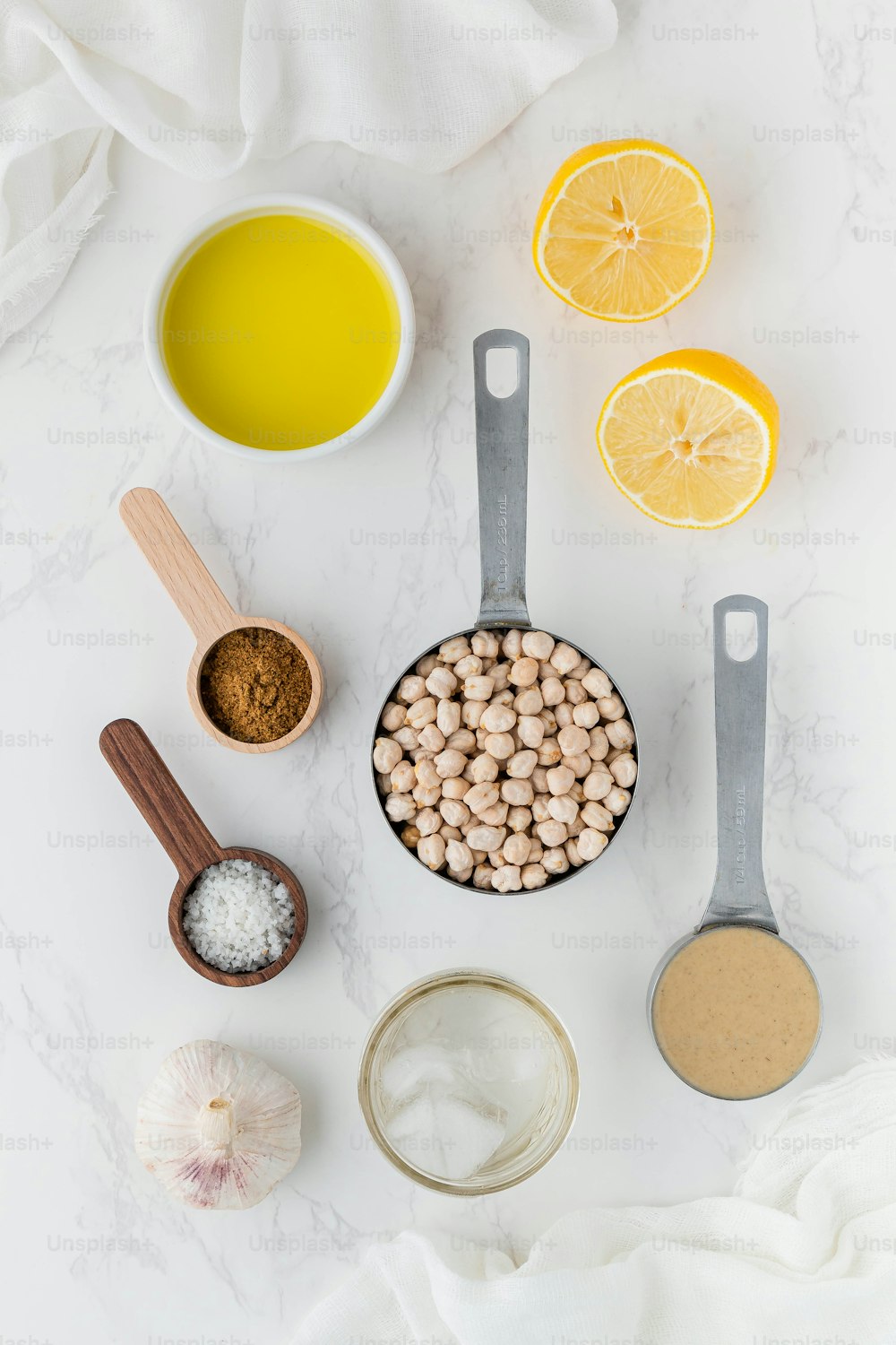 a table topped with bowls of food and measuring spoons