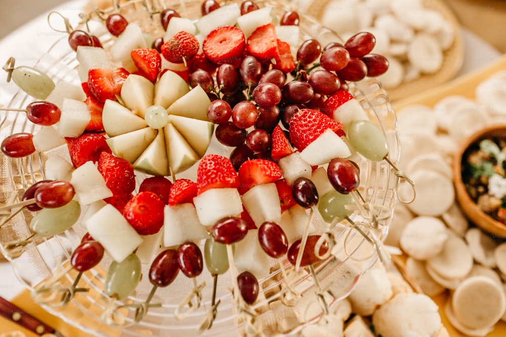 a platter of fruit and cheese on a table