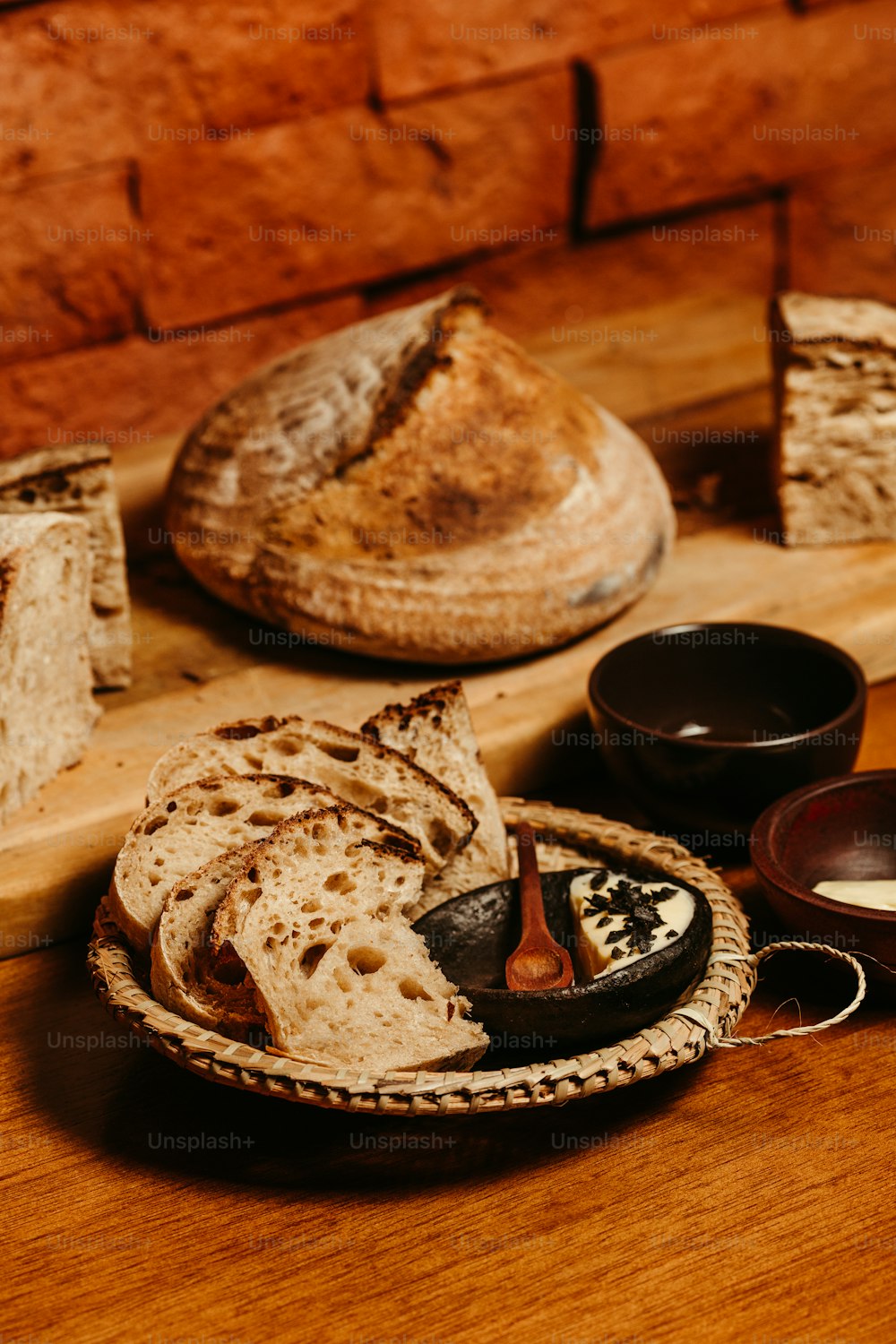 a wooden table topped with bread and other items