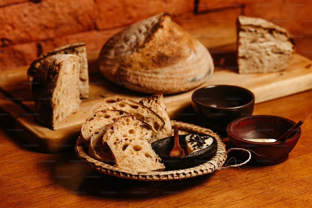a wooden table topped with bread and bowls