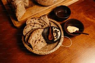 a wooden tray topped with bread and butter