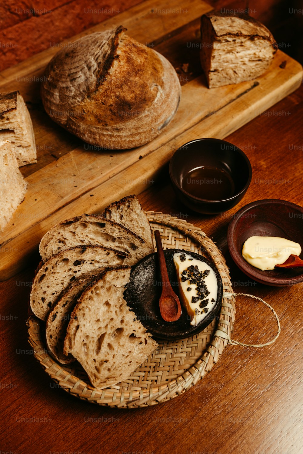 a wooden table topped with bread and other foods