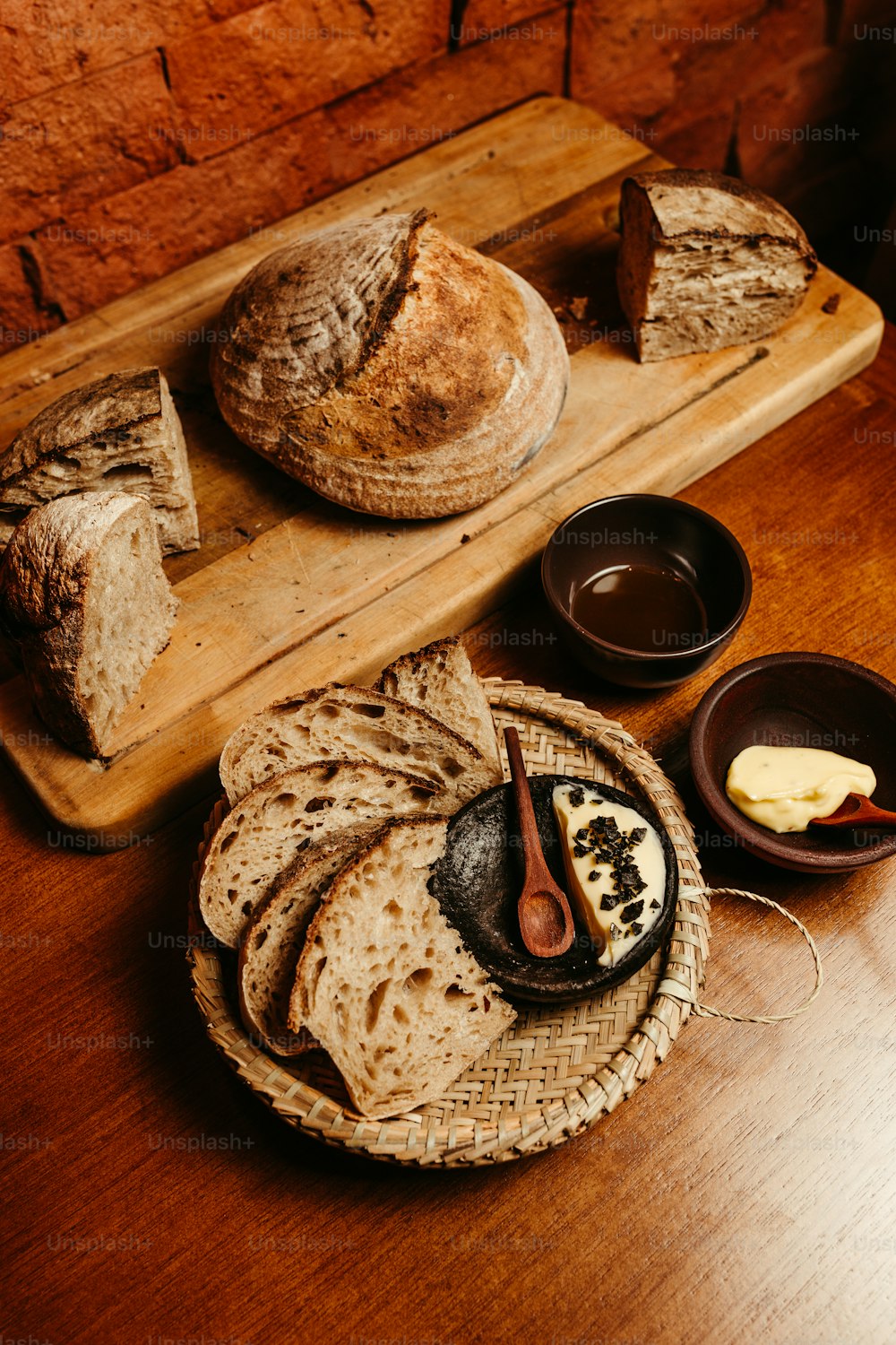 a wooden table topped with bread and butter