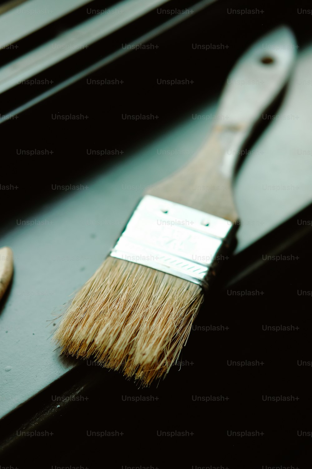 a paint brush sitting on top of a window sill