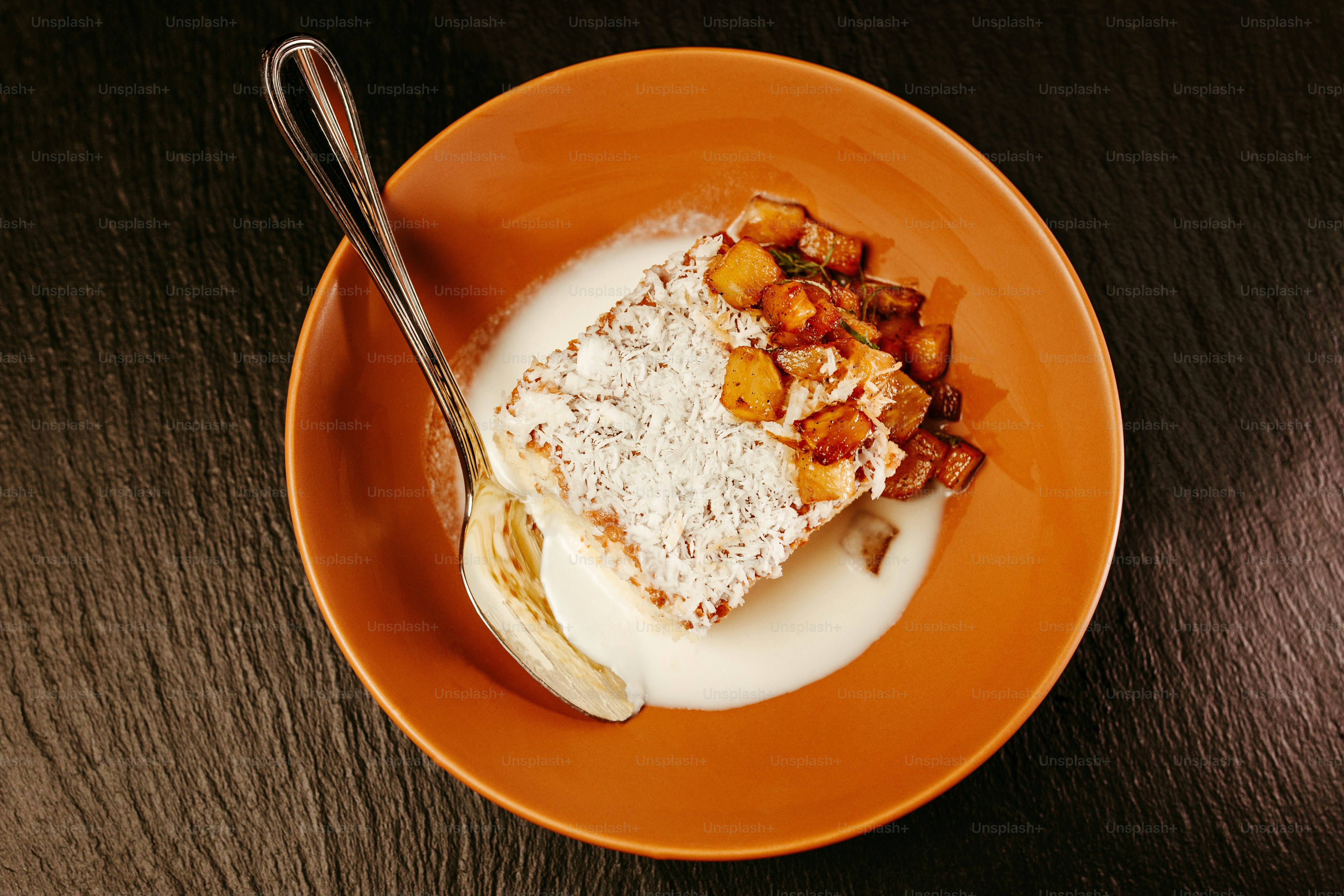 a piece of cake on a plate with a spoon