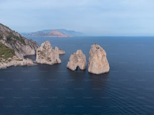 a group of rocks in the middle of a body of water