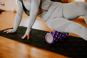 a woman is doing yoga on a mat