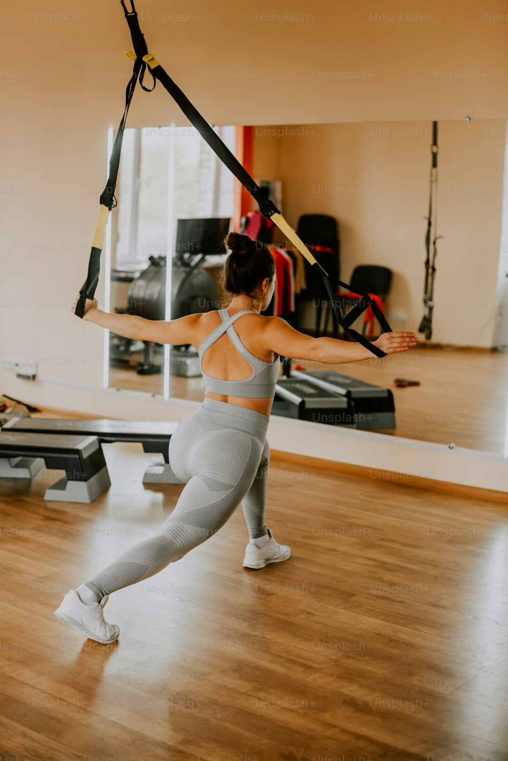 a woman in a gym holding a pole