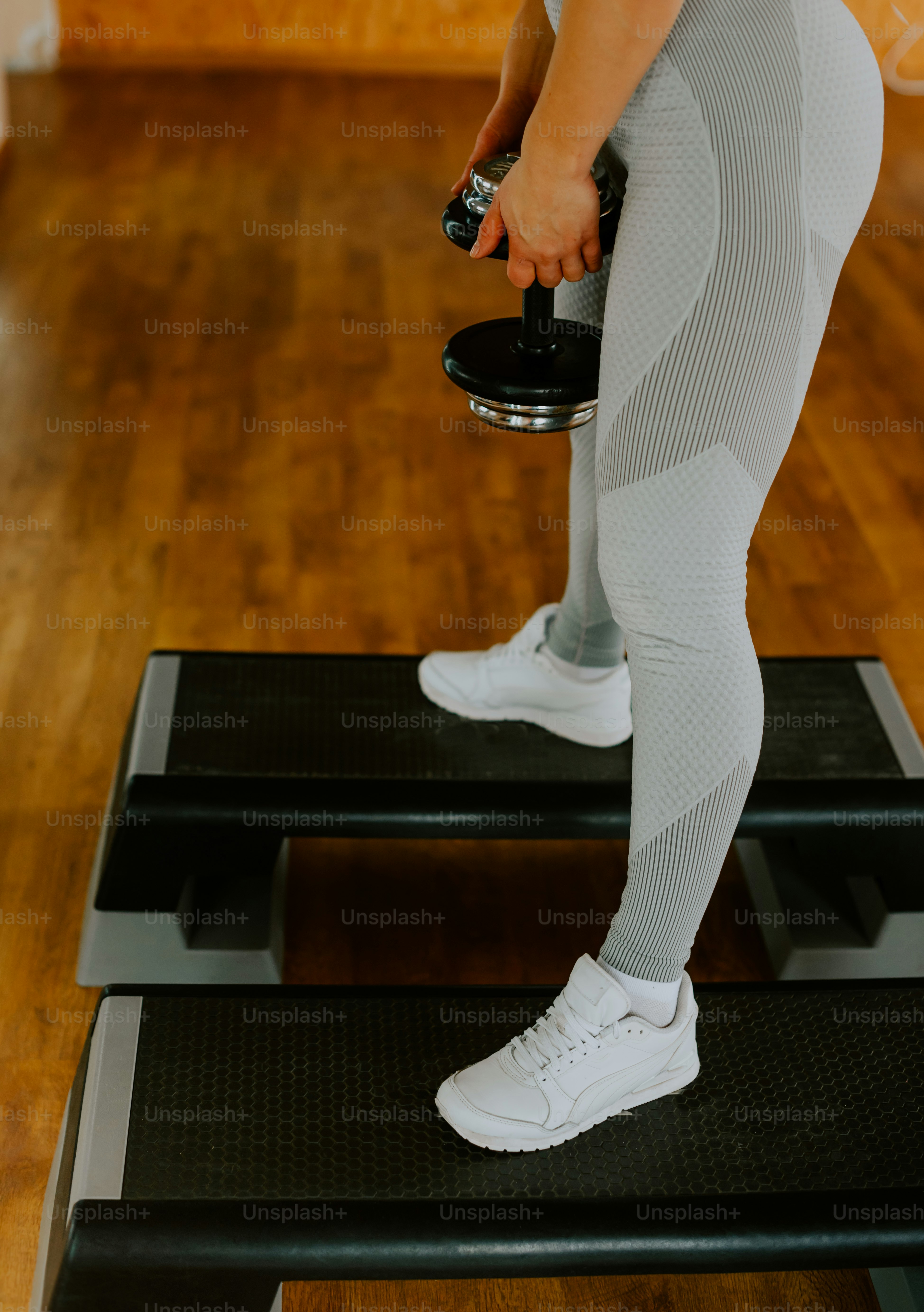 a person standing on a treadmill with a bottle of water